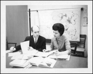 Teachers reviewing recruitment and training materials in a classroom setting